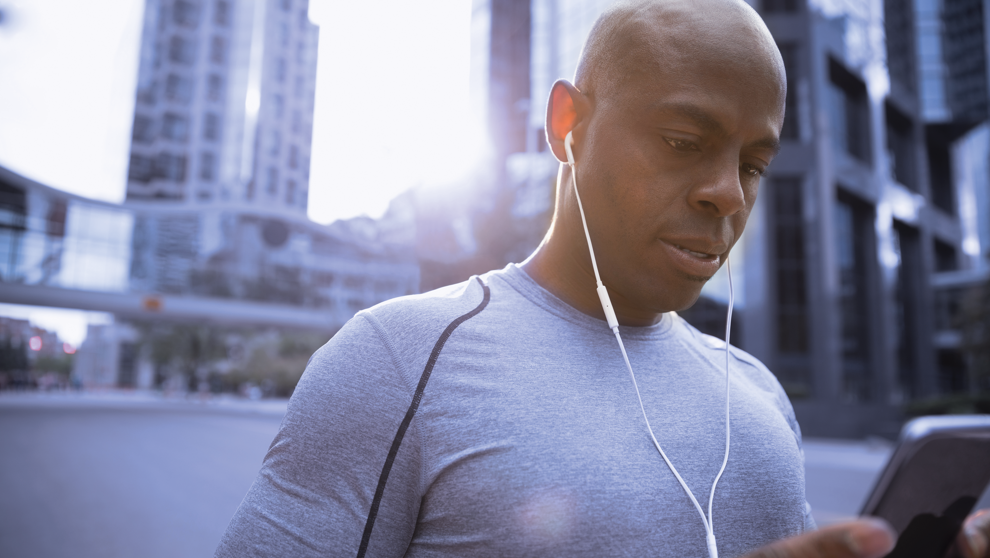 Man with headphones looking at mobile phone