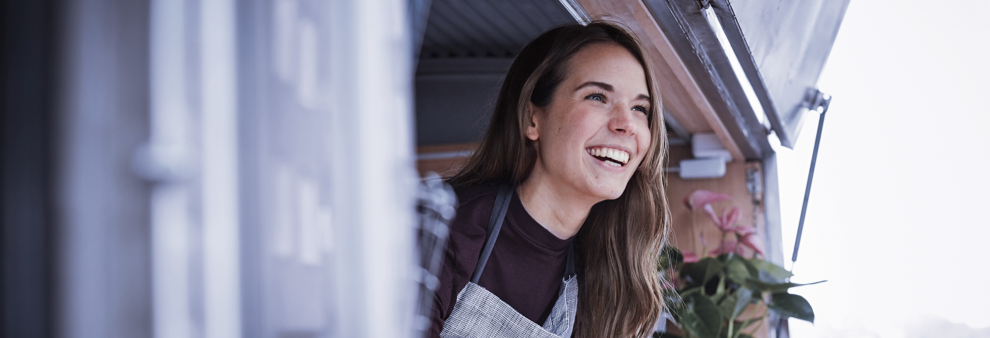 Woman looking out of a mobile kitchen