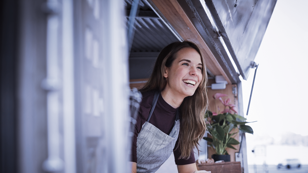 Woman looking out of a mobile kitchen